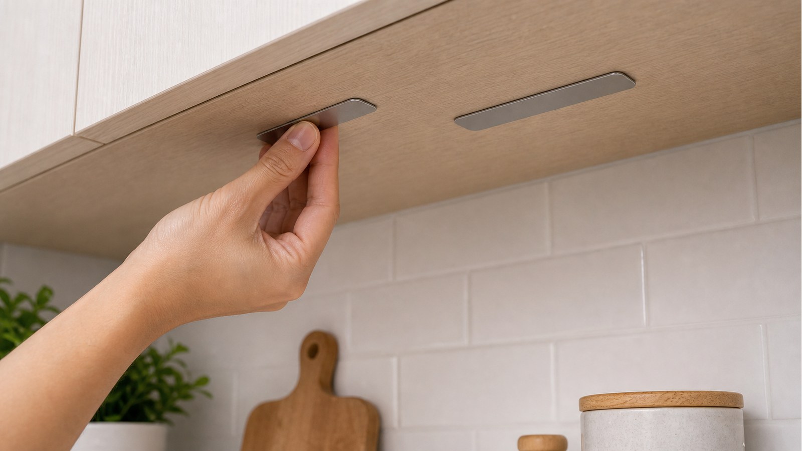 Pressing adhesive metal plates under a kitchen cabinet for a magnetic LED bar